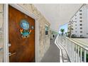 Condo exterior featuring beach-themed decor and an ocean view from the walkway at 1167 Ocean Shore Blvd # 110, Ormond Beach, FL 32176
