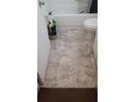 Bathroom with a standard white toilet and tub, featuring a neutral patterned floor at 1228 S Parsons Ave, Deland, FL 32720