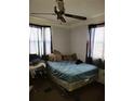 Bedroom featuring a ceiling fan, curtains, and a bed with pillows at 1228 S Parsons Ave, Deland, FL 32720