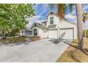 Charming two-story home with a two-car garage, a well-manicured lawn, and large palm tree at 1229 Saddleback Ridge Rd, Apopka, FL 32703