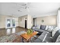 Spacious living room featuring a large sectional couch, wood-look floors and sliding glass doors to outside at 1317 Suwanee Rd, Daytona Beach, FL 32114