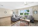Inviting living room with neutral paint, wood-look tile flooring, and lots of natural light at 1317 Suwanee Rd, Daytona Beach, FL 32114
