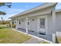 Close-up of a home's entrance featuring a covered porch and well-maintained facade at 150 Reef Rd, South Daytona, FL 32119