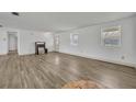 Bright living room with wood-look floors, white walls, and natural light from windows at 150 Reef Rd, South Daytona, FL 32119