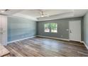 A bright living room showcases modern hard wood floors, a ceiling fan and fresh paint at 1598 Montgomery Ave, Daytona Beach, FL 32117