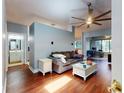 Cozy living room featuring hardwood floors, a ceiling fan, and modern decor at 161 Blue Heron Dr # C, Daytona Beach, FL 32119