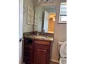 Bathroom featuring a wooden vanity with a granite countertop and framed mirror at 1649 Courtland Blvd, Deltona, FL 32738