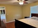 Bedroom features natural light from the window, ceiling fan, and wood-look flooring at 1649 Courtland Blvd, Deltona, FL 32738