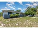 A charming home exterior featuring blue shutters and lush landscaping at 1808 Green Pl, Ormond Beach, FL 32174