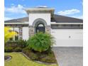 Charming single-story home boasting lush landscaping, stone accents, and an attached two-car garage at 225 Mosaic Blvd, Daytona Beach, FL 32124
