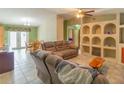 The spacious living room features tiled floors and built-in shelving, perfect for storage at 2333 Fern Palm Dr, Edgewater, FL 32141