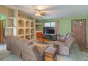 Cozy living room features neutral color scheme, tiled floors and ample seating at 2333 Fern Palm Dr, Edgewater, FL 32141