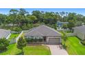 An aerial shot of a cozy home with a well-manicured lawn and mature trees surrounding the property at 2337 Oxmoor Dr, Deland, FL 32724