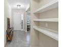 Inviting foyer with a console table, tile flooring, and an open view into the living spaces at 2337 Oxmoor Dr, Deland, FL 32724