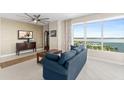 Cozy living room featuring stylish furniture, neutral tones, and a beautiful view of the water at 241 Riverside Dr # 902, Holly Hill, FL 32117