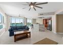 Open-concept living space with water views, a breakfast bar, stainless appliances, and modern finishes at 241 Riverside Dr # 902, Holly Hill, FL 32117