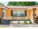 Close-up of home's facade with window planters, front door, and tidy garden bed at 242 Linda Vista St, Debary, FL 32713