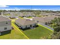 Backyard aerial view of the home with a lawn, white fence, and patio furniture on a sunny day at 2518 Hoptree Ln, Edgewater, FL 32141