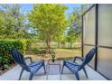 Outdoor patio features a lake view, outdoor seating, and privacy screen at 258 Rustic Loop, Sanford, FL 32771