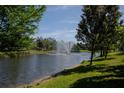 Scenic pond with a fountain surrounded by lush greenery and trees, enhancing the community's appeal at 258 Rustic Loop, Sanford, FL 32771