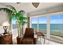 A cozy armchair providing ocean views and modern ceiling lighting at 2937 S Atlantic Ave # 1907, Daytona Beach Shores, FL 32118