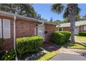 This townhome has a well-maintained exterior with a walkway and trimmed shrubs at 3 Fairway Ct, Deland, FL 32724