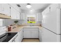 Efficient kitchen features bright cabinetry and ample counter space at 3 Fairway Ct, Deland, FL 32724