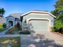 Daytime view of a charming single-Gathering home with a two-car garage at 307 Stonington Way, Deland, FL 32724