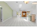 Open-concept living room with tile floors and sliding glass doors to the patio, creating a seamless indoor/outdoor flow at 3214 Juniper Dr, Edgewater, FL 32141