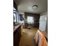 Modest kitchen featuring wood cabinets and essential appliances at 326 South St, De Leon Springs, FL 32130