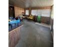 Spacious living area with wood paneling and abundant natural light at 326 South St, De Leon Springs, FL 32130