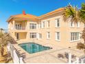 A private backyard with a spacious pool, and a balcony overlooking the pool at 33 Ocean Shore Blvd, Ormond Beach, FL 32176