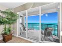 Relaxing balcony with seating overlooking the ocean and beachfront, with sliding glass doors offering ample natural light at 3311 S Atlantic Ave # 1704, Daytona Beach Shores, FL 32118
