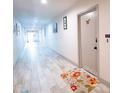 Hallway with wood-look tile flooring, neutral paint, and decorative accents at 3800 Saxon Dr # 150, New Smyrna Beach, FL 32169