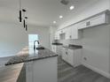 Kitchen features granite countertops, white cabinets and stainless steel appliances at 516 Model St, Daytona Beach, FL 32114