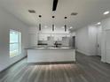Bright, open-concept kitchen with granite countertops, a kitchen island and stainless steel appliances at 516 Model St, Daytona Beach, FL 32114