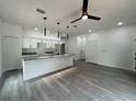 Bright, open-concept kitchen with granite countertops, a kitchen island and stainless steel appliances at 516 Model St, Daytona Beach, FL 32114