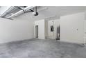 Spacious garage with overhead lighting and room for storage at 561 Coronado Cove Road, New Smyrna Beach, FL 32168