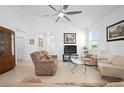 Bright living room with tile flooring, a ceiling fan, and ample natural light at 5610 Nw 37Th Lane Rd, Ocala, FL 34482