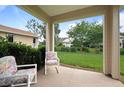 Inviting covered patio with comfortable seating and a view of the lush backyard at 5610 Nw 37Th Lane Rd, Ocala, FL 34482