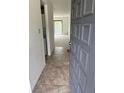 Inviting condo foyer with tiled flooring, with washer and dryer hookups, and view of the living area at 600 N Boundary Ave # 114-C, Deland, FL 32720
