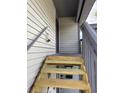 Wooden stairway leading to the second floor entrance, offering easy access to the upper level at 600 N Boundary Ave # 114-C, Deland, FL 32720