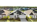 Aerial view of a home in a neighborhood with lush greenery and well-maintained lawns at 617 Mosaic Blvd, Daytona Beach, FL 32124