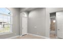 Bright and airy bedroom with neutral walls, tile floor and an ensuite bathroom at 617 Mosaic Blvd, Daytona Beach, FL 32124