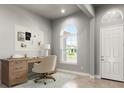 Bright office space with a wooden desk, comfortable chair, and natural light at 617 Mosaic Blvd, Daytona Beach, FL 32124