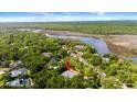 Scenic aerial view of a home nestled amongst lush greenery with a river nearby, creating a private retreat at 6185 Shoreline Dr, Port Orange, FL 32127