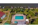 Community pool with lounge chairs surrounded by landscaping, palm trees, and water views at 719 S Beach St # 302B, Daytona Beach, FL 32114