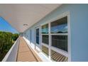 Exterior view of the condo building with a walkway, balcony, and water views at 719 S Beach St # 302B, Daytona Beach, FL 32114