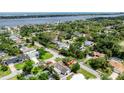 Wide aerial shot showcasing the property's neighborhood, lush landscaping, and proximity to the bay at 952 Northbrook Dr, Ormond Beach, FL 32174