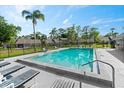 Community pool featuring a sparkling pool, lounge chairs, and well-maintained deck, perfect for relaxation and recreation at 102 Bob White Ct # 102C, Daytona Beach, FL 32119